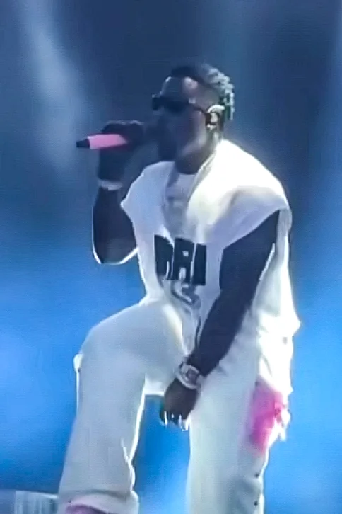 Frenna in a white outfit on stage with a matt pink wrapped wireless microphone by WRPPN