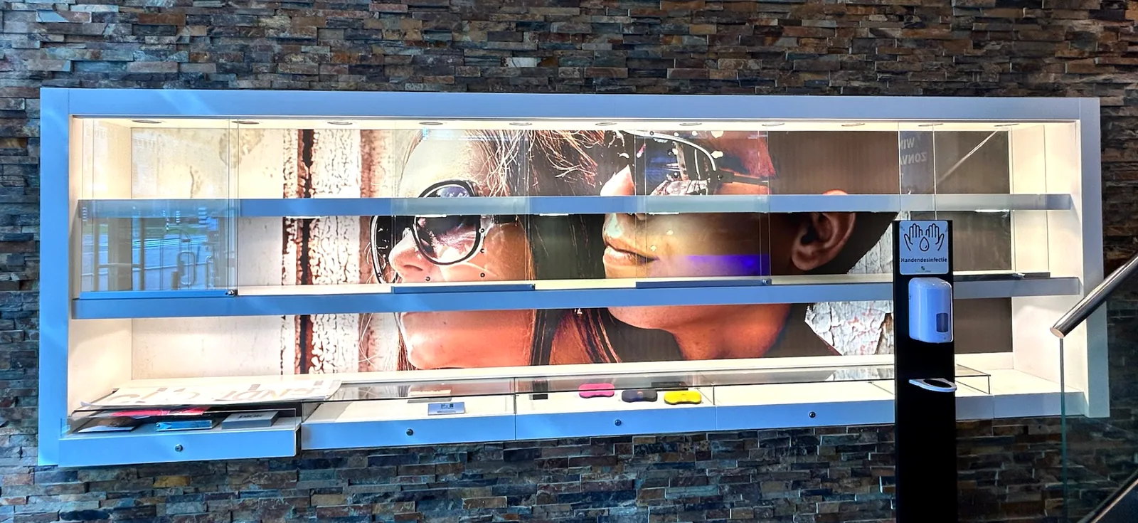Before: the same display wall with a busy photo print