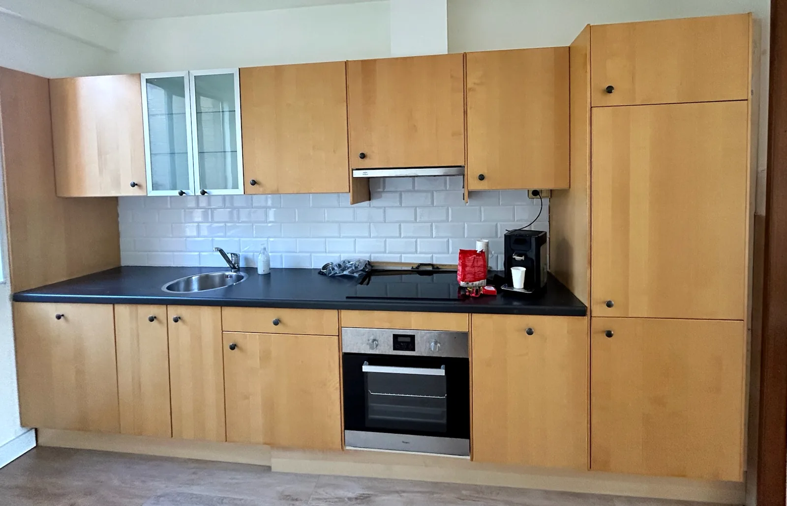 Before: the same kitchen with wood-look fronts
