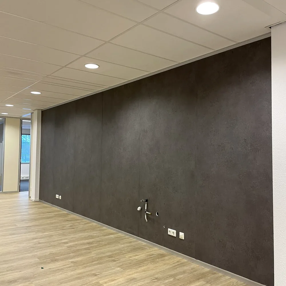Office wall in a dark stone look above a light wood floor
