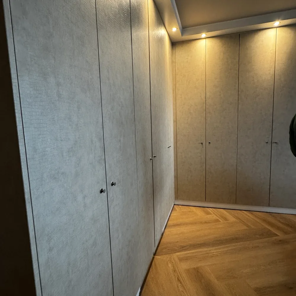Cabinet wall in a beige leather look, seen from the side