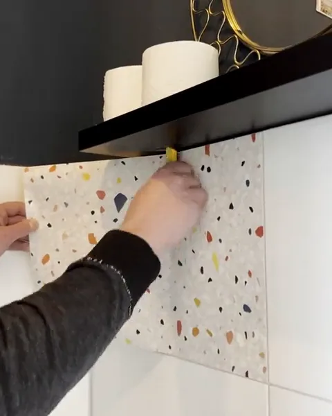 Terrazzo film is applied over white tiles