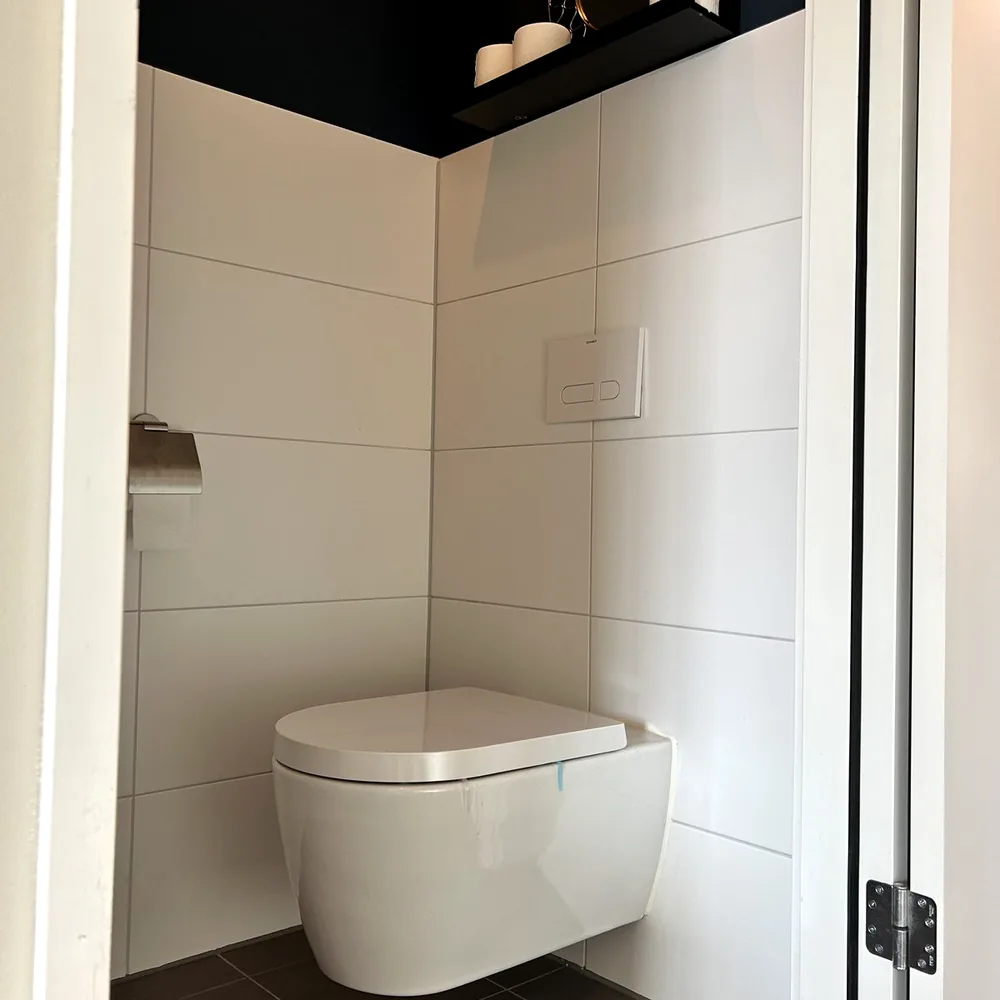 Before: the same washroom with white tiles
