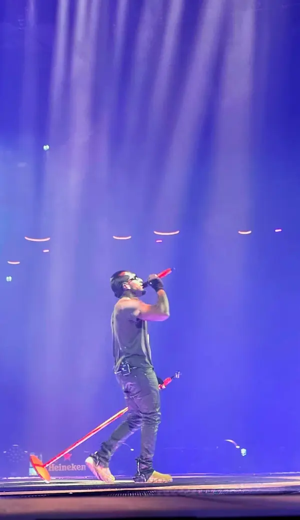 Frenna on stage with a red wrapped microphone