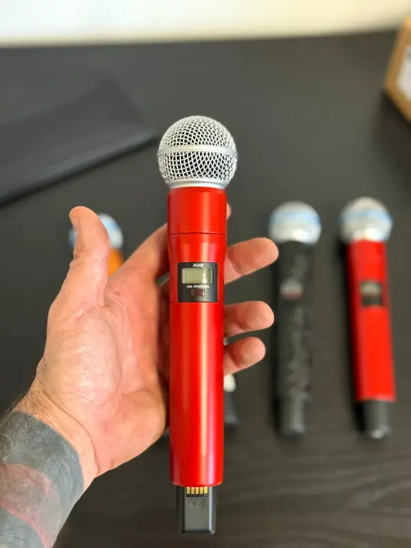 Hand with a microphone in high-gloss red