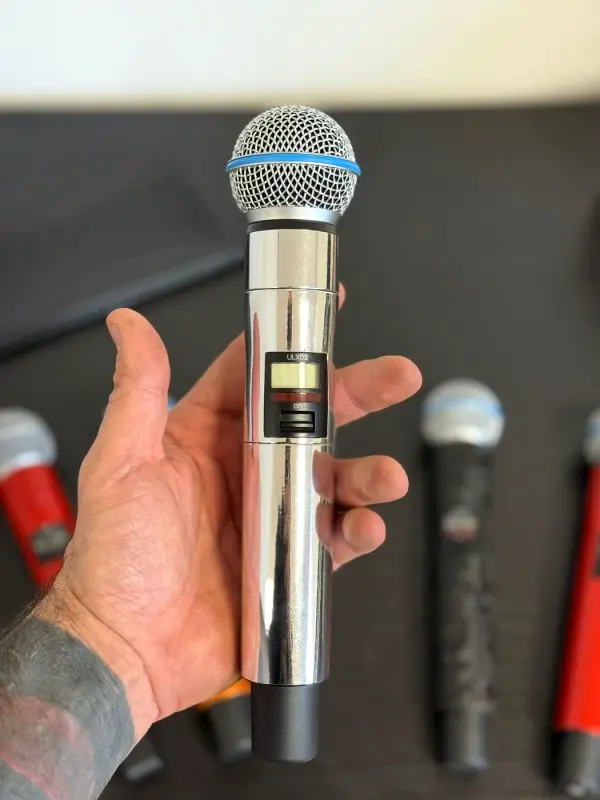 Hand with a microphone in mirror chrome