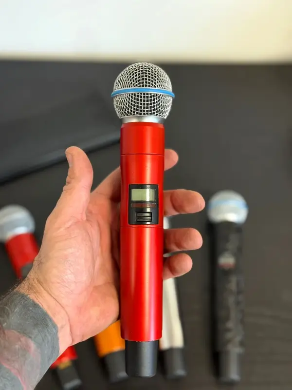 Hand with a microphone in satin red