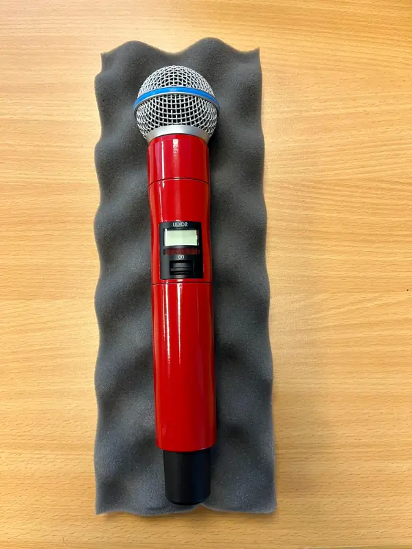 Microphone in gloss red on grey foam
