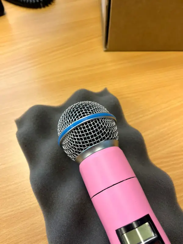 Head of the matt pink microphone, close up