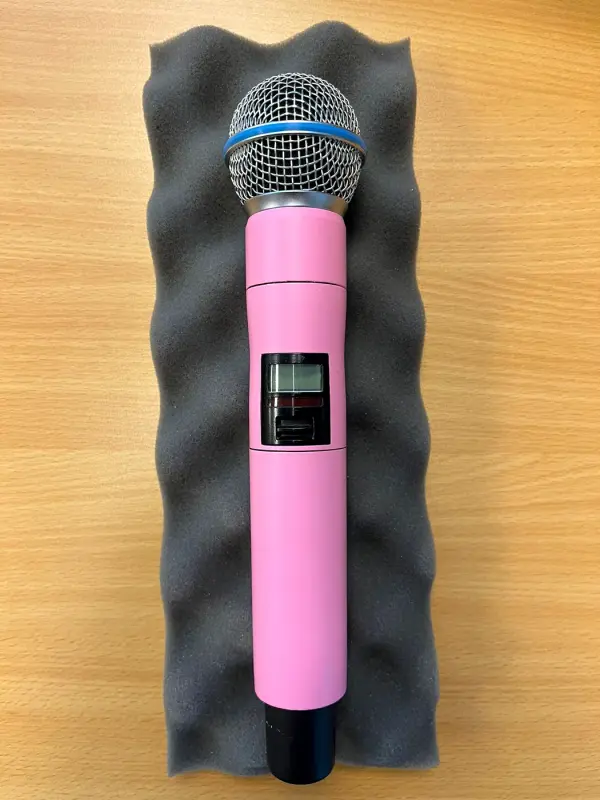 Microphone in matt pink on grey foam