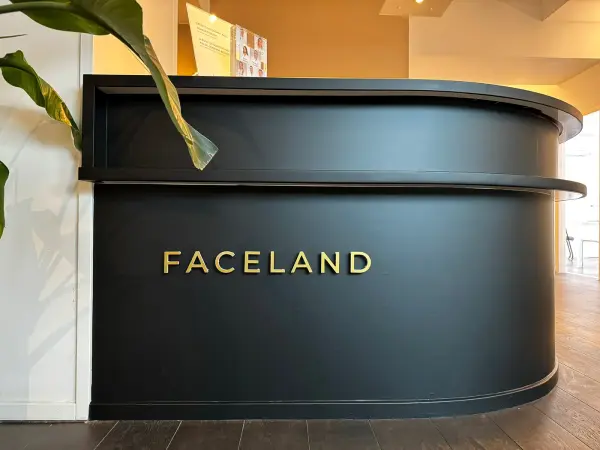 Faceland reception desk in matt black with gold lettering