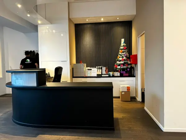 Reception area with the black desk and a Christmas tree