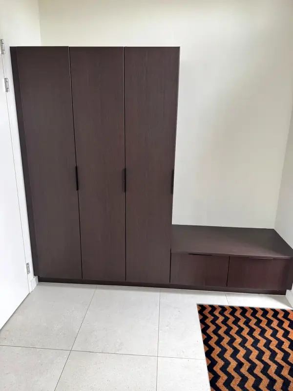 After: wardrobe in dark wood with a bench