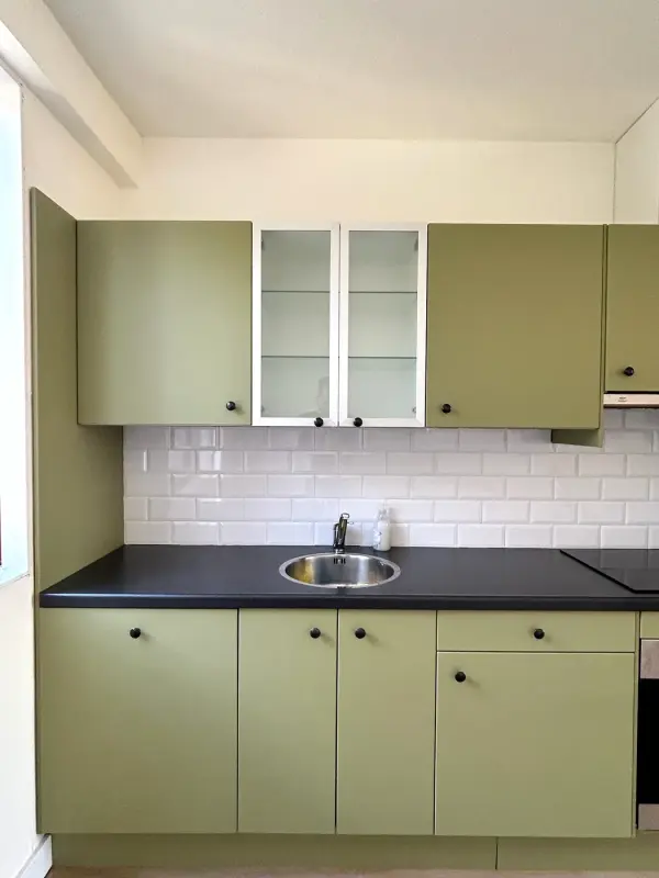 After: green kitchen with sink and white tiles