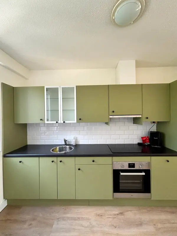 After: green kitchen under the ceiling light