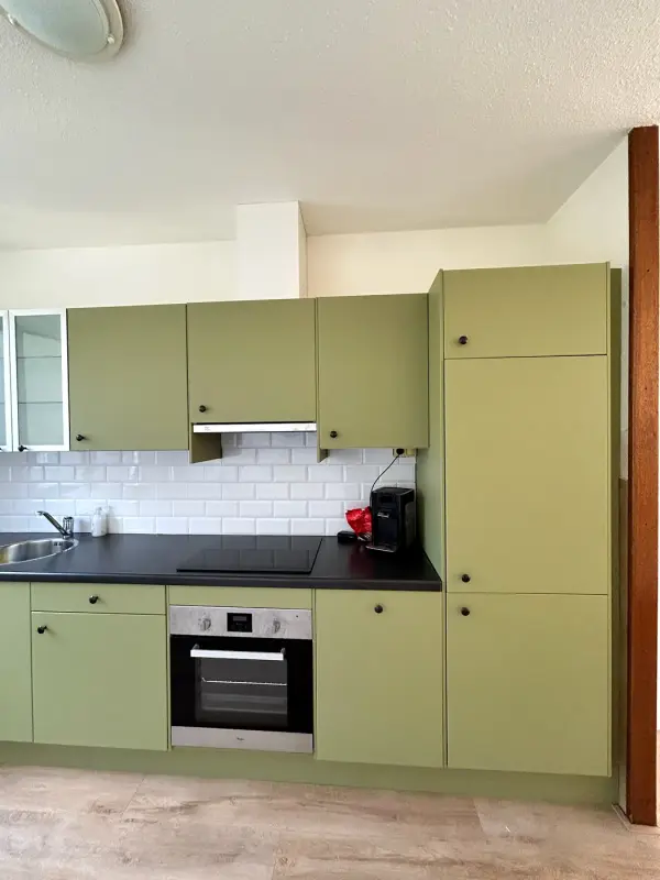 After: green kitchen wall with a tall cabinet