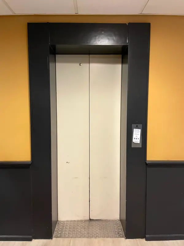 Before: lift doors in white and metal