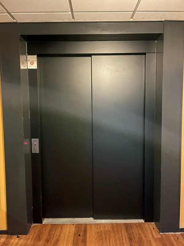 After: lift doors in matt black, close up