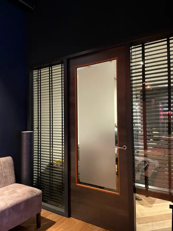 After: door with privacy film next to a seating area