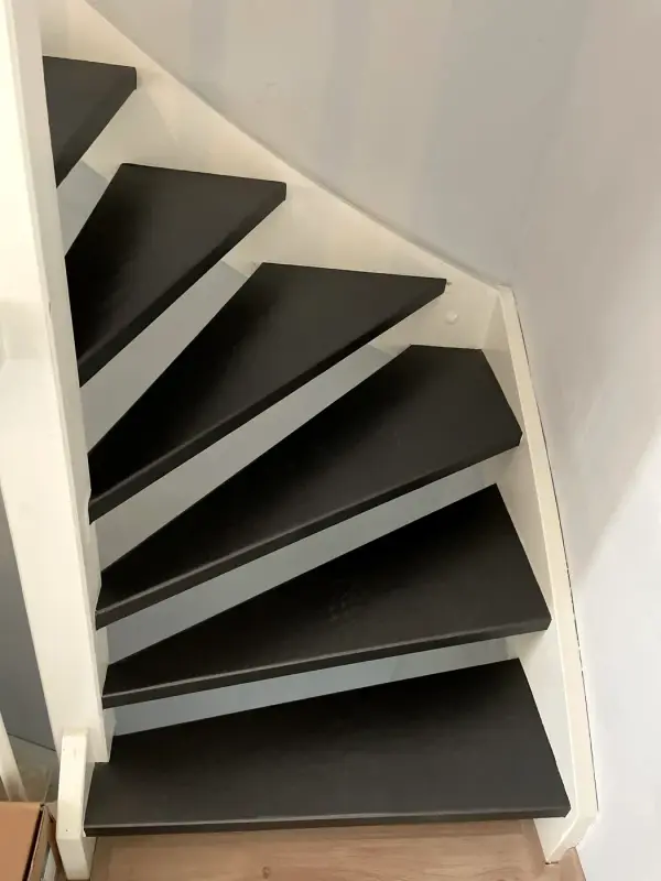 Winding stairs with black treads, from above