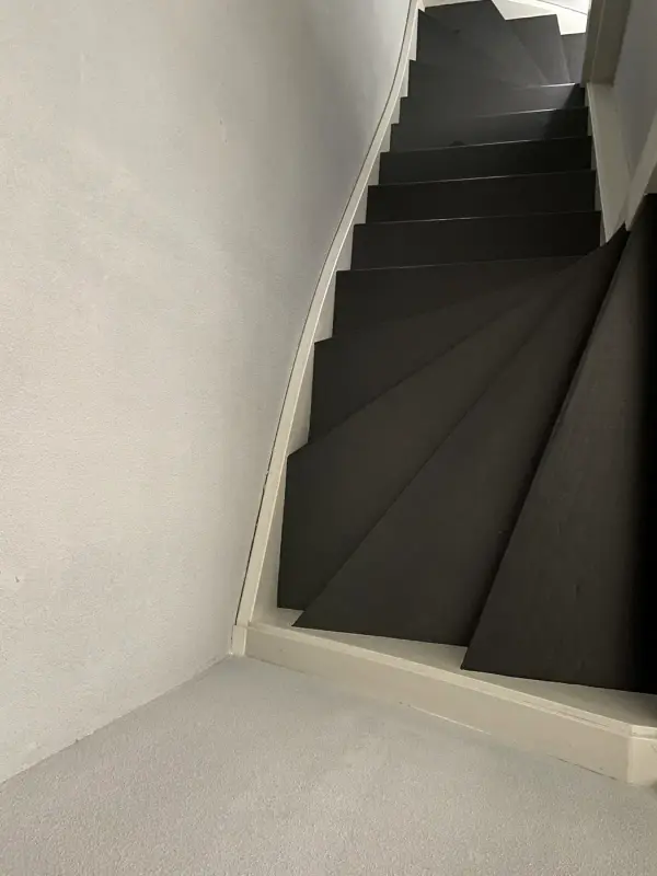 Straight stairs in black, seen from below