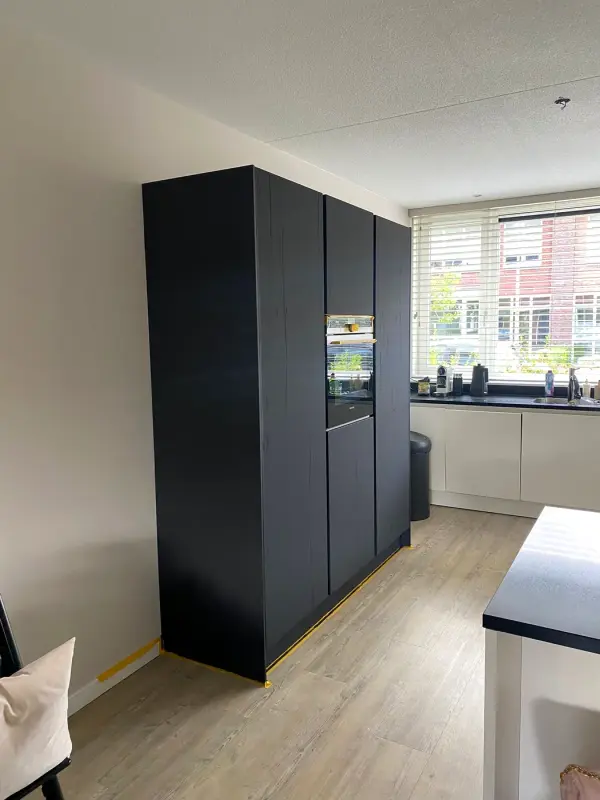 After: tall cabinet in dark matt
