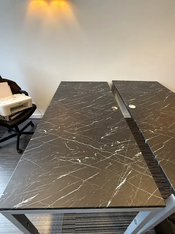 Desk tops in a black marble look with white veins, close up