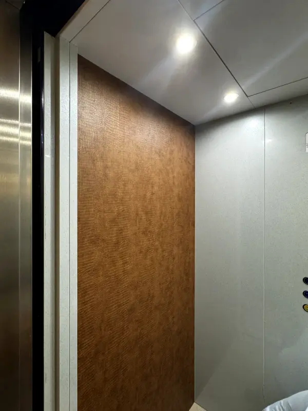 Lift car with a side wall in a brown leather look