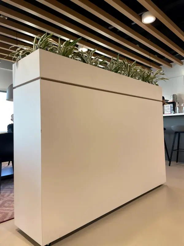 Before: white room divider with planter, from the front at an angle