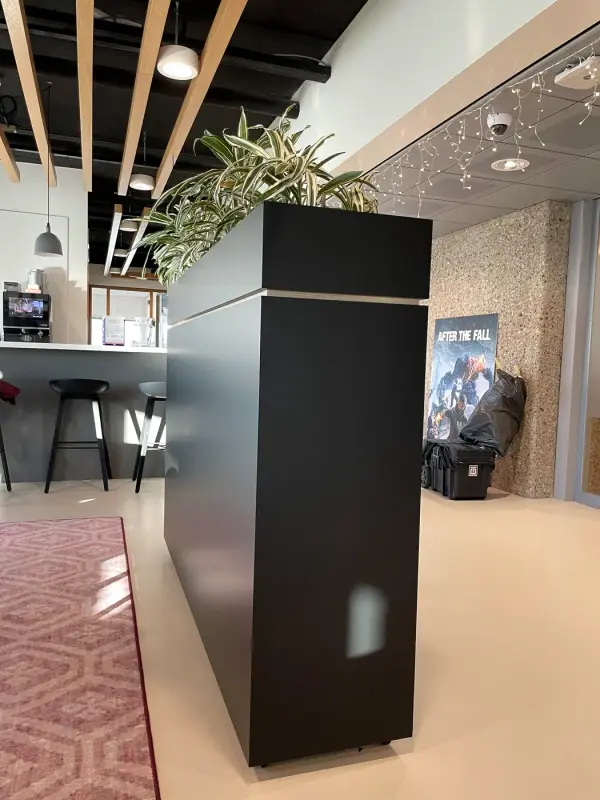 After: room divider with planter in matt black, from the front at an angle