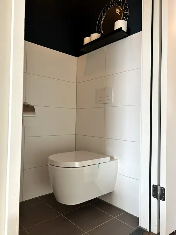 Before: washroom with white tiles