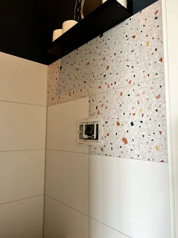 During: terrazzo film partly applied around the flush plate