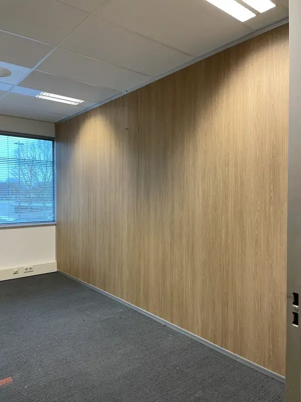 Corridor with a dark stone-look wall and a light wood floor